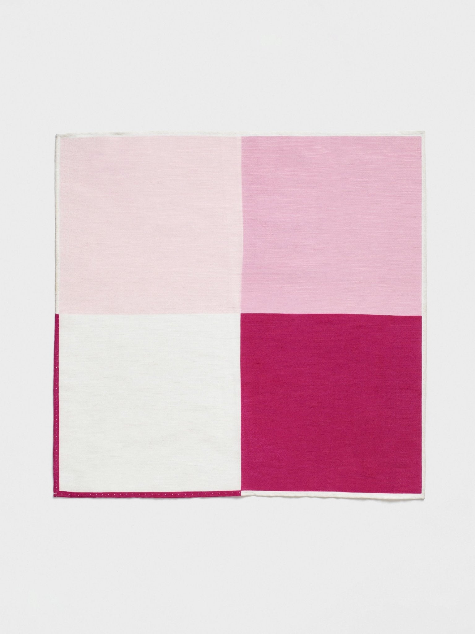 A square fabric with four sections in varying shades of pink and white.