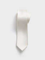 A rolled white tie with a textured pattern on a light background.