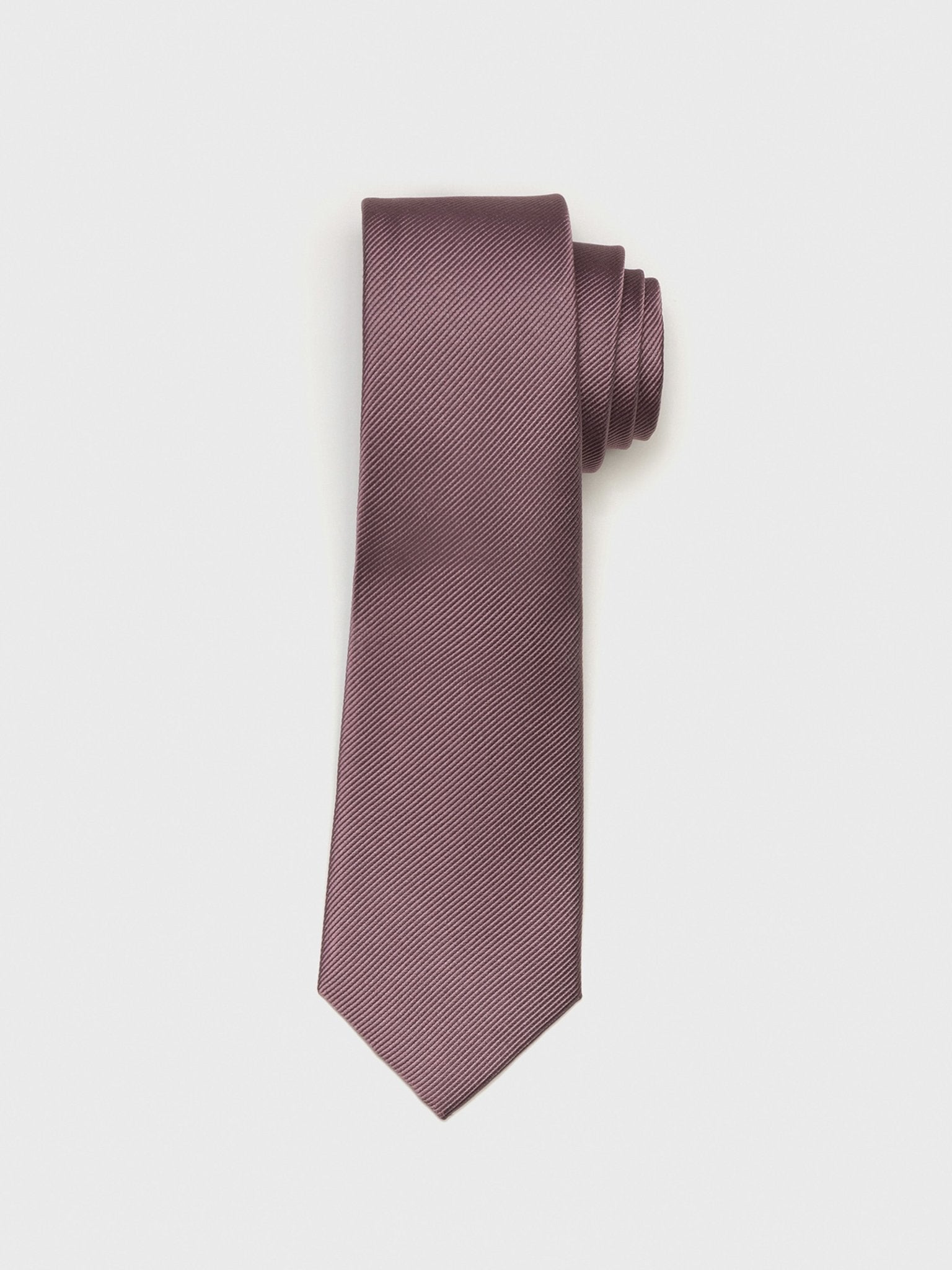 A rolled-up purple tie with a textured pattern.
