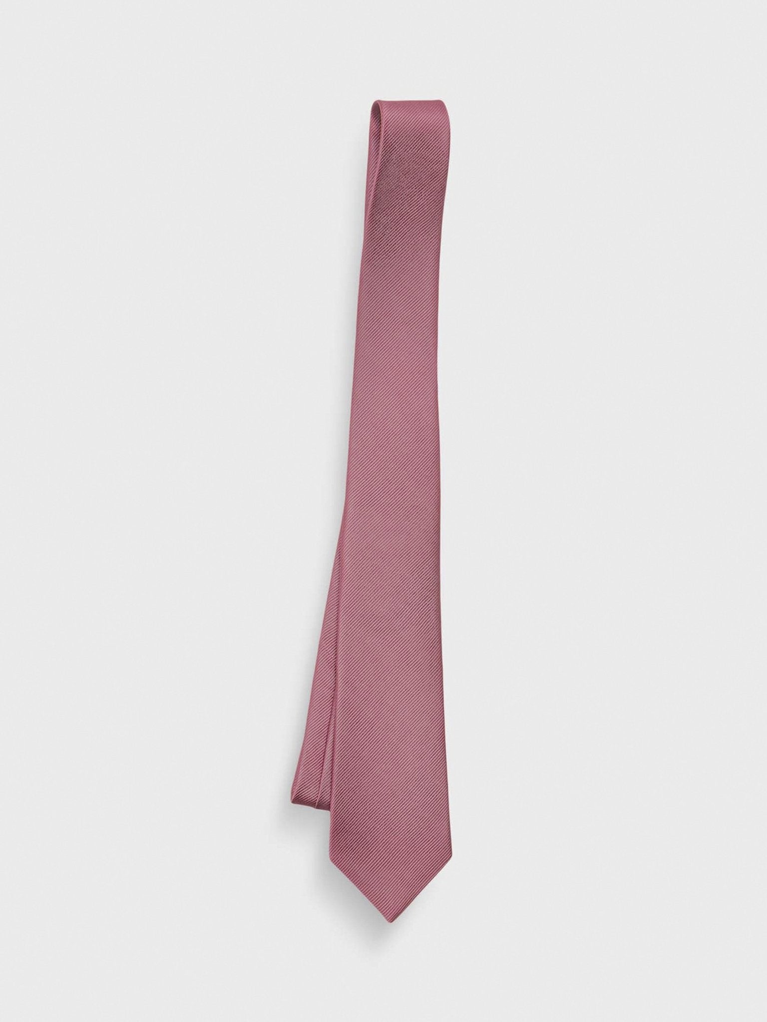 Solid pink tie hanging against a white background.