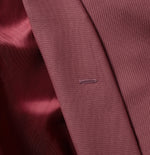 Close-up of a maroon fabric with a small stitched label.