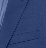 Close-up of a blue suit jacket with a pocket and lapel visible.