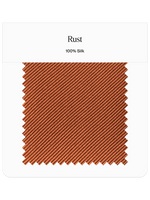 Rust colored silk fabric swatch with a textured pattern.