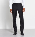 Man wearing black formal trousers and shiny black shoes with a white shirt.