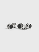 Four pairs of silver cufflinks with black centers on a white background.