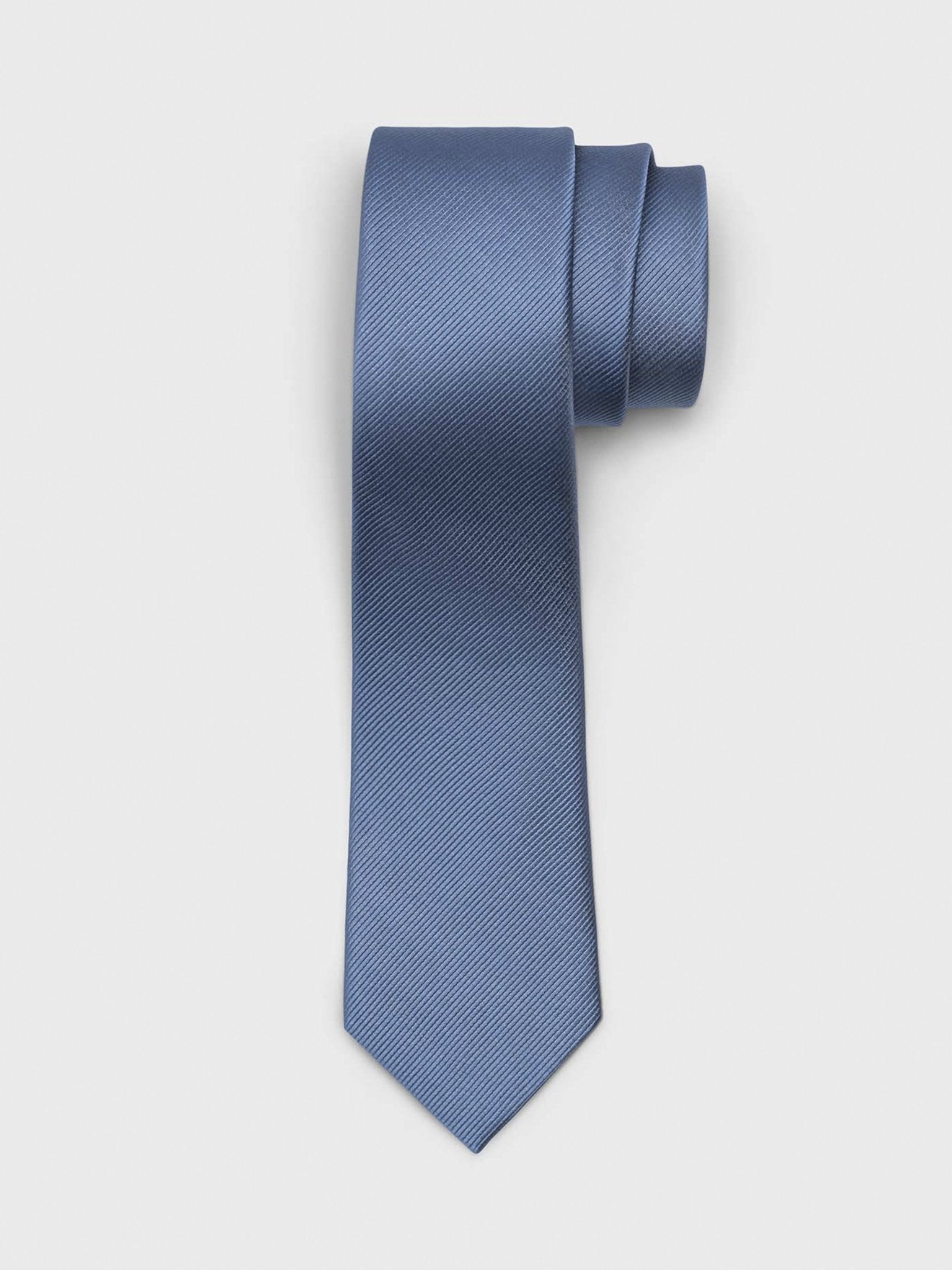 Solid blue tie with a textured pattern, rolled at the top.