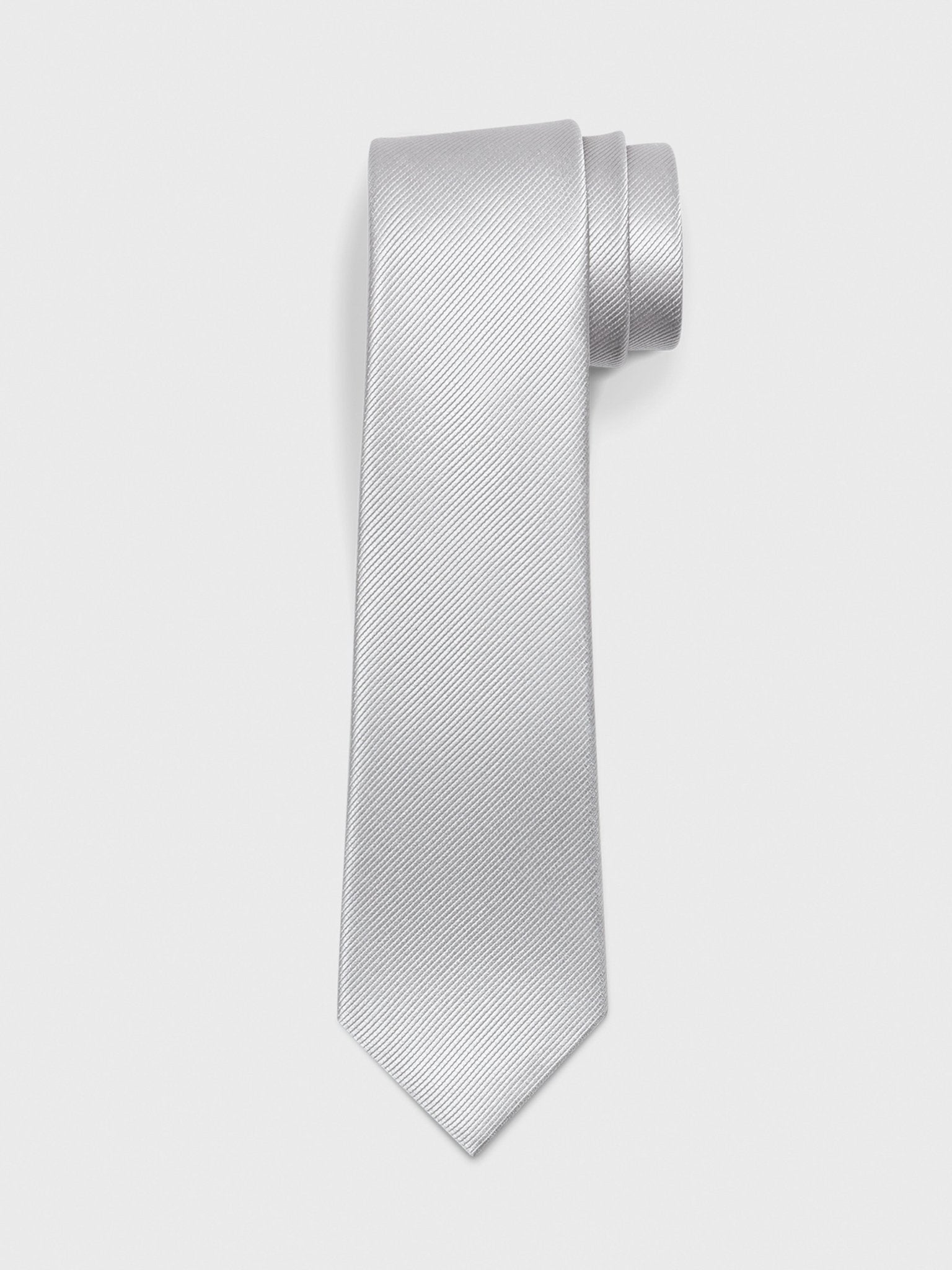 Silver tie with a textured pattern, rolled at the top.