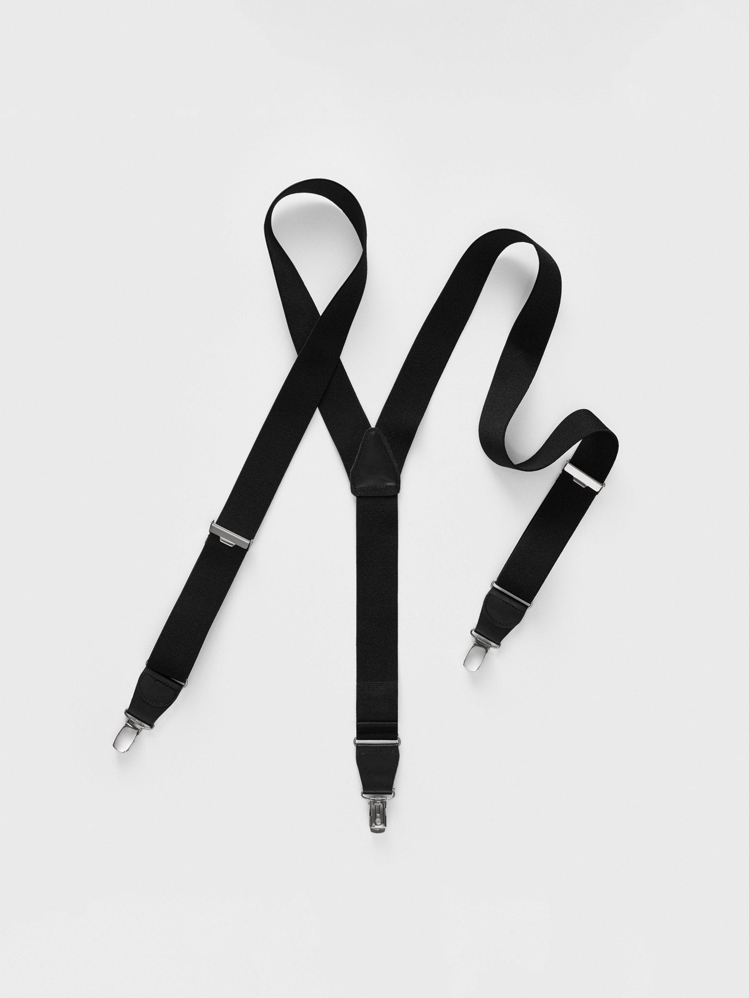 Black suspenders with clips on a white background.