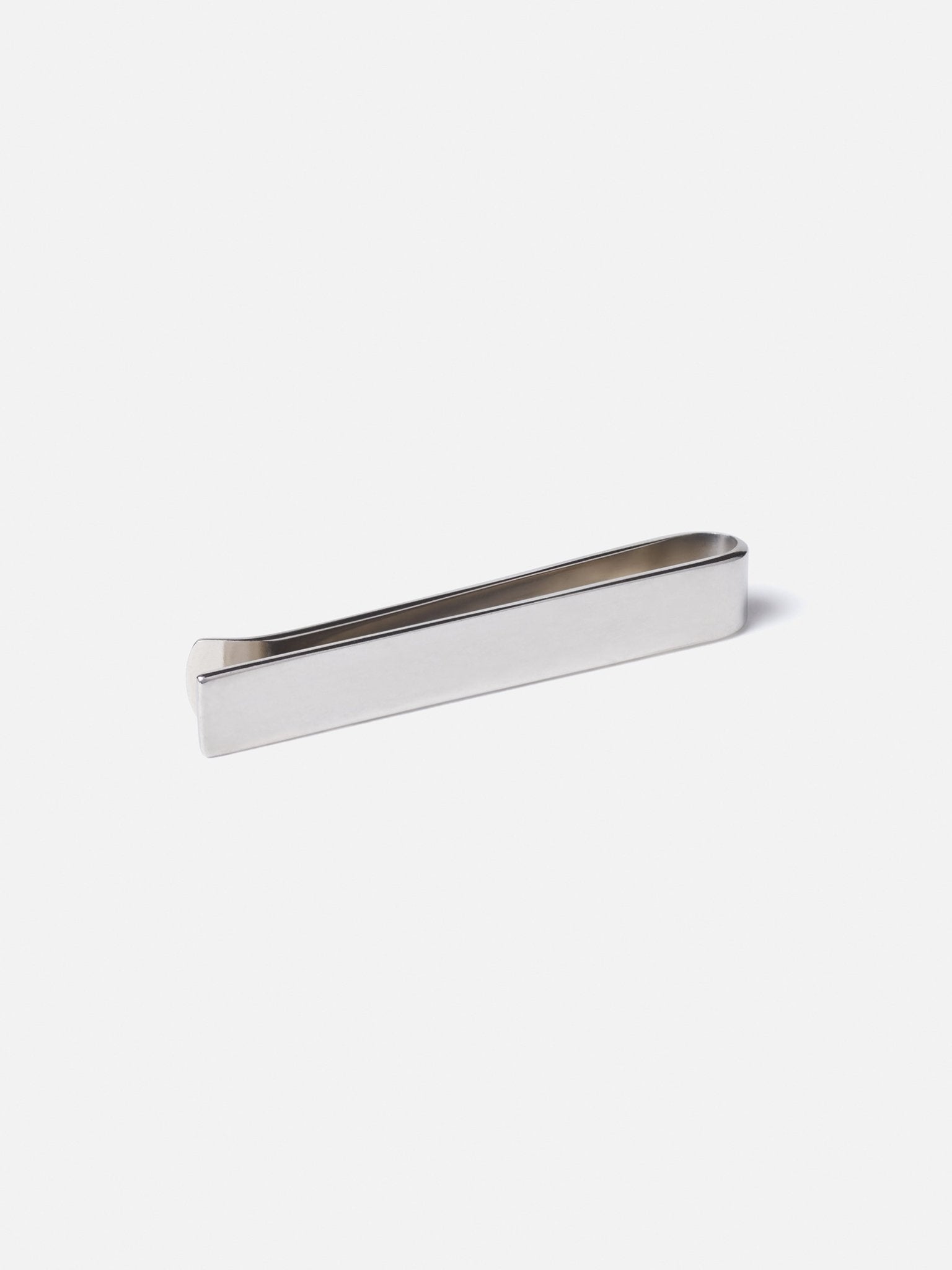 Silver tie clip on a white background.