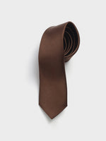 Brown tie with a textured pattern, coiled neatly.