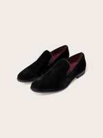 Black velvet loafers with a smooth finish and maroon interior.