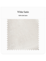 Sample of white satin fabric labeled as 100% silk satin.