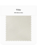 Swatch of white fabric labeled 100% Merino Wool.
