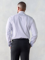 Man wearing a white dress shirt and black pants, viewed from the back.