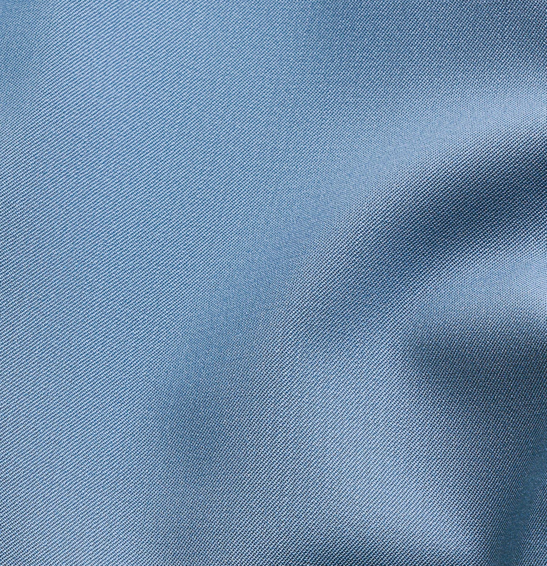 Close-up of light blue fabric with a textured weave.