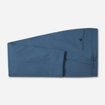 Blue suit pants folded neatly with a button and pocket detail.